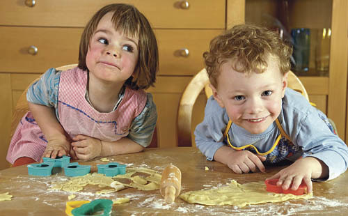 Ein Bube und ein M?del beim Pl?tzchenbacken - Vorfreude auf das Weihnachtsfest