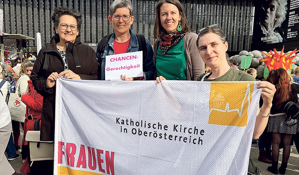 Mitglieder der Frauenkommission mit ihrer neuen Fahne bei der Kundgebung am Weltfrauentag. 
