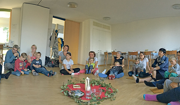 Die Kerze in der Mitte wird bei jedem Treffen von den Kindern gestaltet. Mit dem Eröffnungslied „Gott ist da“ beginnt das Treffen.