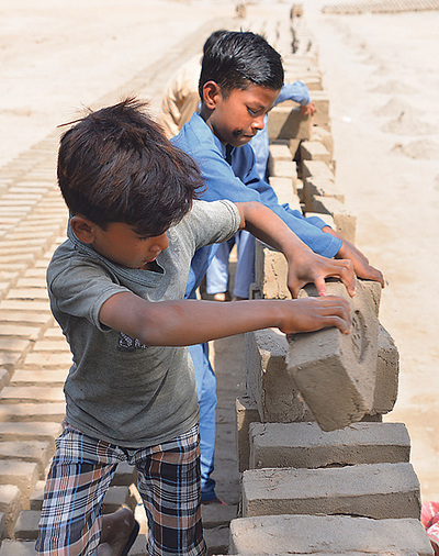 Kinder bei der Arbeit in einer pakistanischen Ziegelfabrik.  