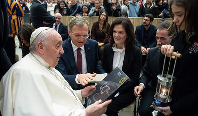 Sarah überreicht dem Papst das Friedenslicht . Dahinter Landeshauptmann Thomas Stelzer mit Ehefrau Bettina Stelzer-Wögerer.
