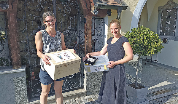 Gabi Emathinger (links) und Karina Buchinger (rechts) vom Pfarrblatt-Team Kinderseite mit der Schatzkiste 