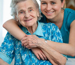 Senior woman with her caregiver at home