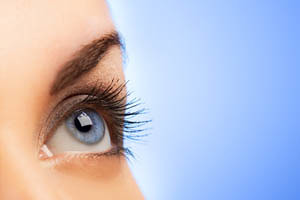 Human eye on blue background (shallow DoF)