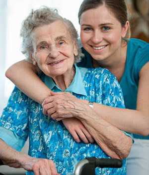 Senior woman with her caregiver at home